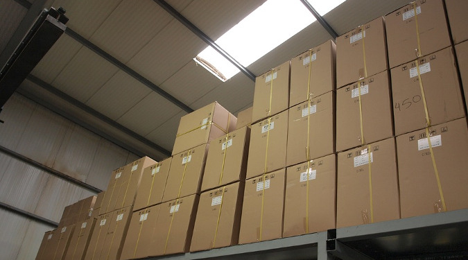 Cardboard Boxes ready for shipping in a warehouse with a skylight.