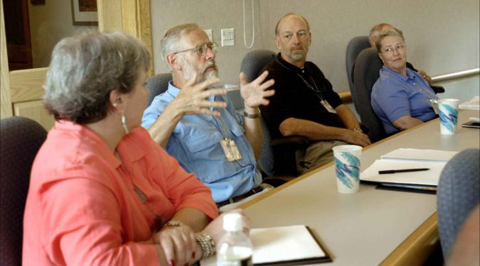 Products are run through a chemist and then a small group of testers. People sitting around a table discussing items.